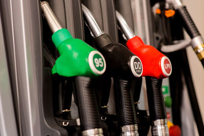 Close-up of multi colored fuel pumps at gas station