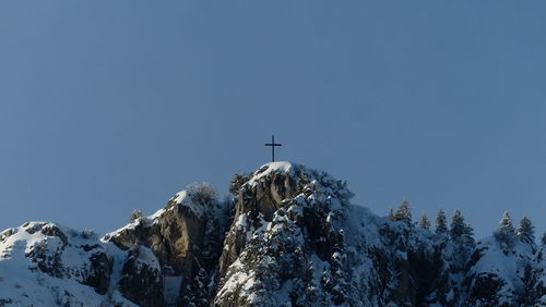 Low angle view of snowcapped mountains against clear sky