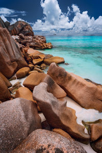 Rocks on beach against sky