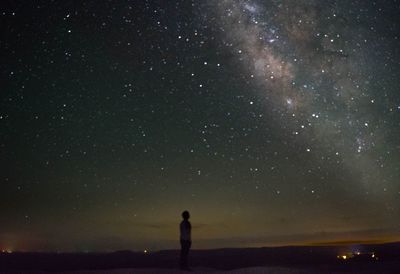 Man looking at milky way at night