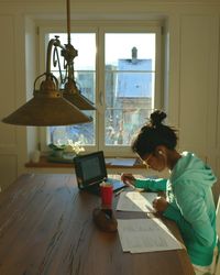 Teenager studying on desk at home