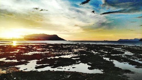 Scenic view of sea against sky at sunset