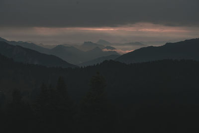 Scenic view of silhouette mountains against sky during sunset