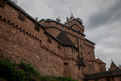 Low angle view of historical building against cloudy sky