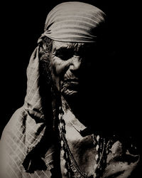 Close-up portrait of man against black background