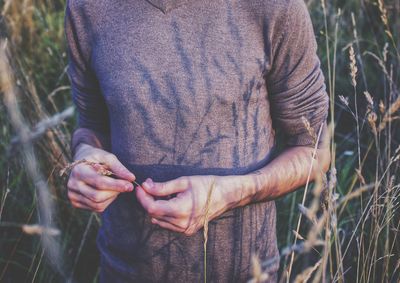 Midsection of man standing on field