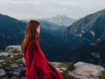 Midsection of woman looking at mountains