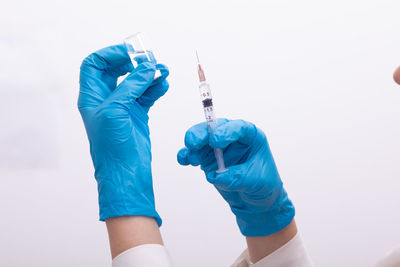 Doctor holding syringe and medicine in hospital