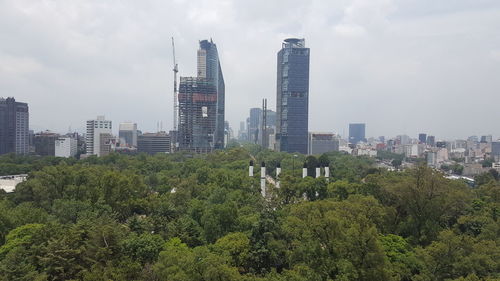 View of cityscape against cloudy sky