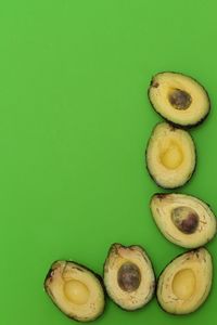 Close-up of fruits against green background