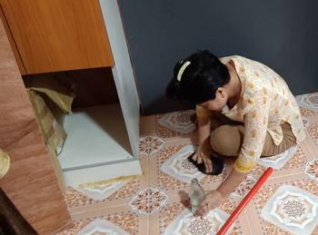 High angle view of woman relaxing on bed at home