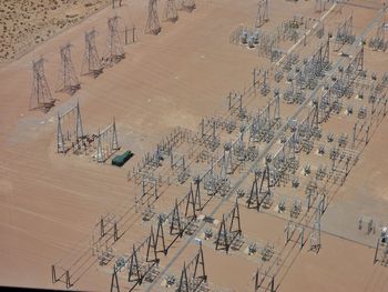 High angle view of electricity pylons on field