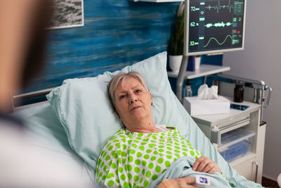 Woman lying on hospital bed