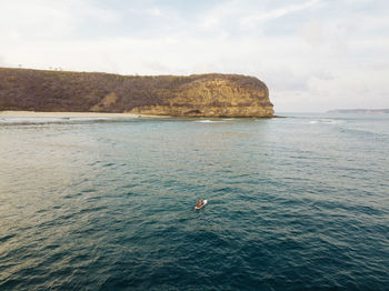 Aerial view of surfer in indian ocean near lombok island