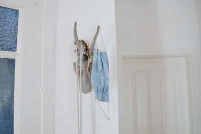 Clothes hanging on white wall at home