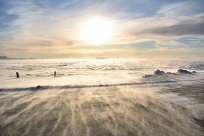 Scenic view of beach against sky during sunset