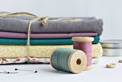 Close-up of sewing item and textiles on table