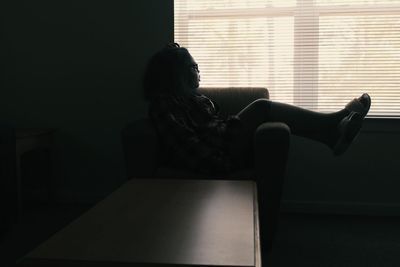 Woman sitting in corridor