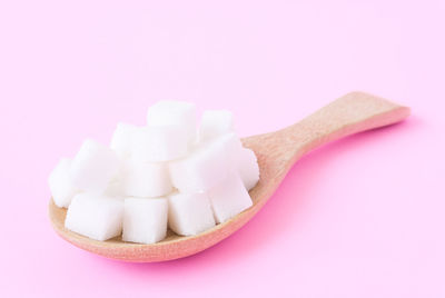 Close-up of pink over white background