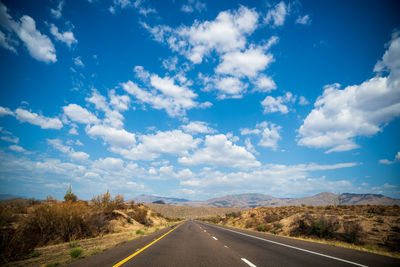 Empty road along countryside landscape