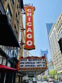 Low angle view of chicago theatre  sign against buildings in city