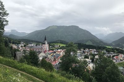 Town by mountains against sky