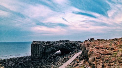 Scenic view of sea against cloudy sky