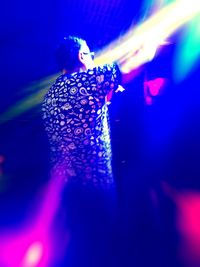 View of woman enjoying music concert