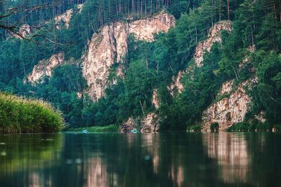 Scenic view of lake by trees on mountain