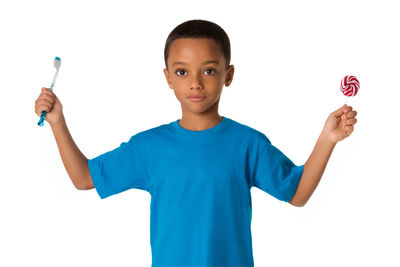 Portrait of boy standing against white background