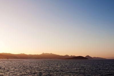 Scenic view of sea against clear sky during sunset