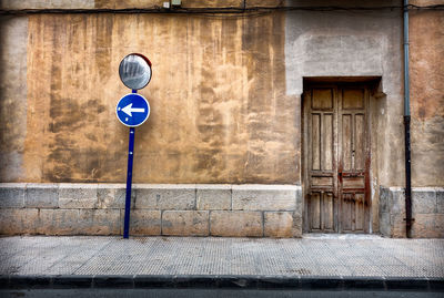 Road sign by built structure