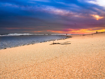 Scenic view of beach against sky during sunset