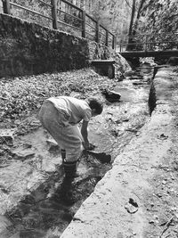 Side view of man working in water