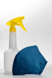 Close-up of yellow bottle against white background