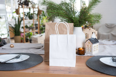 Midsection of woman holding gift on table