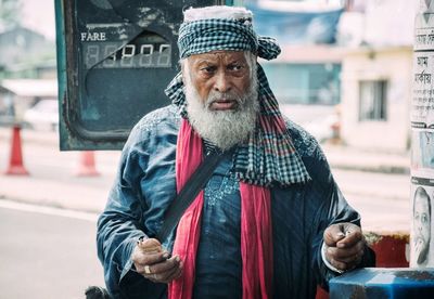 Portrait of man standing in city