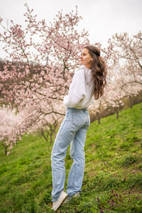 Rear view of woman standing on field