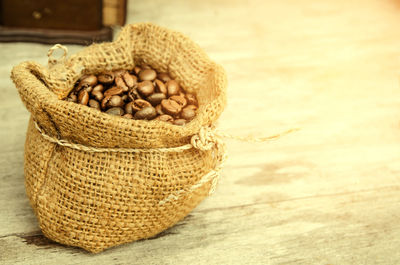 Close-up of roasted coffee bean in sack