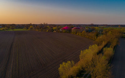 Scenic view of field against sky during sunset