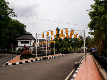 Empty road along buildings