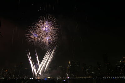 Low angle view of firework display at night