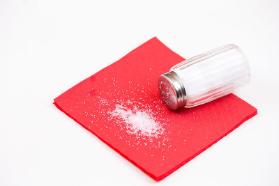 High angle view of red glass on white background