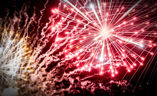 Low angle view of firework display at night