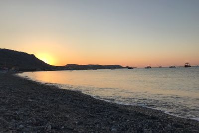 Scenic view of sea against clear sky during sunset