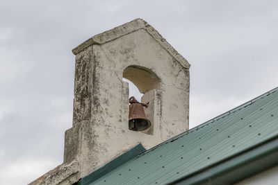 Low angle view of bell tower against sky