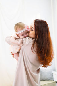 Mother is hugging her little daughter. maternal hugs. concept of mother care.