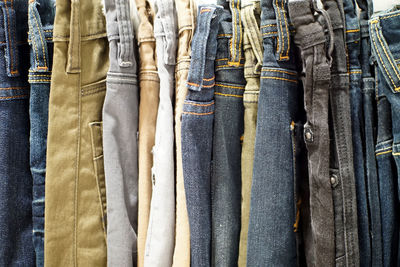 Full frame shot of jeans hanging for sale in store