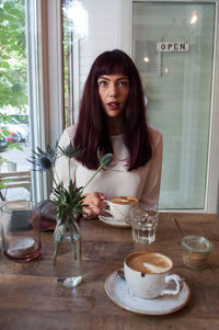 Portrait of young woman on table