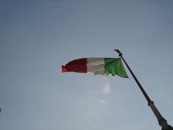 Low angle view of flags against clear sky